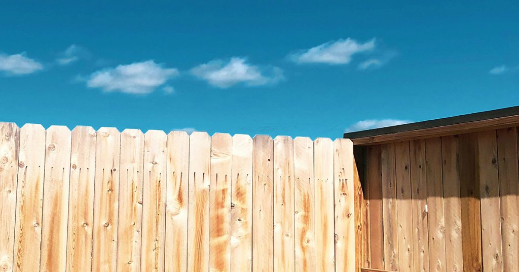 fence in front of blue sky